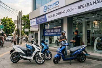 Close up of an Emmo electric motorcycle logo and charging port representing new EV market entry in Indonesia.